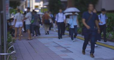 Walking office worker at the city street in Tokyo in summer video
