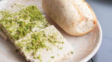 Sliced Pistachio Halvah with Fresh Bread on Rustic Plate video