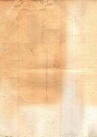 Interesting texture of old paper, soiled and damaged, as well as darkened by time and use, on a white background. Unique vintage texture of old paper which is approximately 60-70 years old. photo