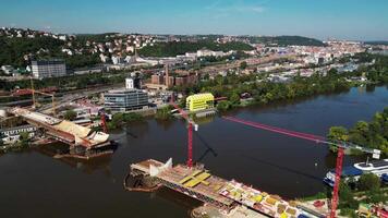 Aerial backwards view of Dvorecky bridge construction over Vltava river in Prague Czechia in September 2024 video