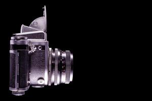 Side view of vintage camera isolated on black background photo