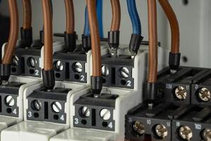 Close up of electrical terminal blocks with connected wires photo