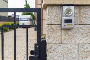 Gated driveway with intercom system and caravan parked photo