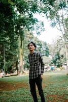 Southeast Asian man standing in a city square, enjoying the surroundings. photo