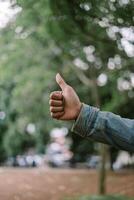 Hand making an 'OK' gesture with the thumb and index finger, conveying positivity and agreement. photo