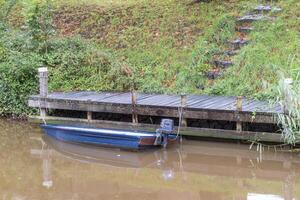 small blue boat on the wooden jetty photo