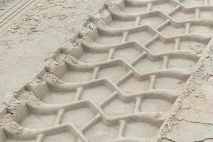 rough tire tracks on the north sea beach photo