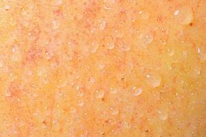 Texture of a yellow and red apple with water drops as a background. photo