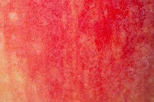 Red and yellow apple texture with water drops as background. photo