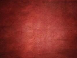 Red suede vignette edge dark and light in the center of the frame. photo