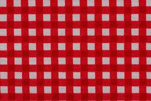Checkered fabric white with red as background macro photo. photo