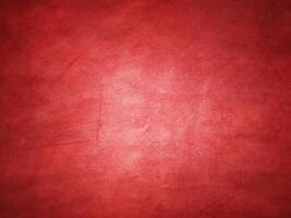 Red suede vignette edge dark and light in the center of the frame. photo