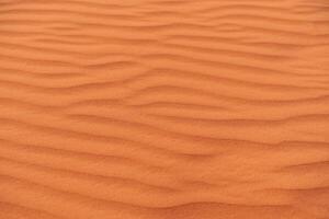 Desert patterns of wind-sculpted sand dunes in Wadi Ram located in the Sahara during sunsets warm glow photo