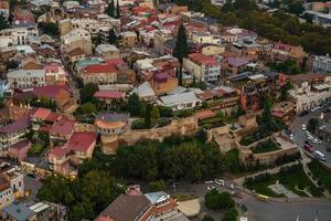 Aerial view of Tbilisis historic district with colorful rooftops and ancient fortifications photo