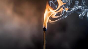 A burning match on a dark background photo