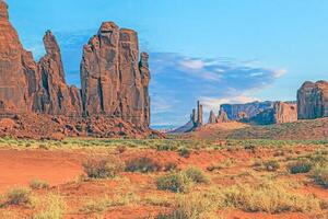 Panoramic picture of the glowing red geological sandstone formations in Monument Valley photo