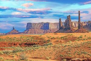 Panoramic picture of the glowing red geological sandstone formations in Monument Valley photo