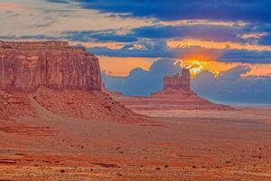 Panoramic picture of the glowing red geological sandstone formations in Monument Valley photo
