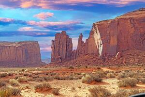 Panoramic picture of the glowing red geological sandstone formations in Monument Valley photo