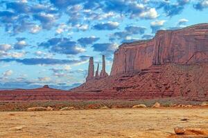 Panoramic picture of the glowing red geological sandstone formations in Monument Valley photo