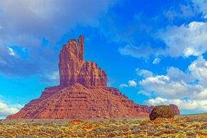 Panoramic picture of the glowing red geological sandstone formations in Monument Valley photo