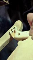 Lathe machine tool head with drill goes down and carves plywood sheet in woodwork shop closeup. Automated instrument with connected brush at plant. High quality 4k footage video