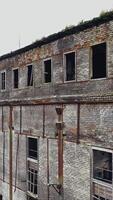 Ruins of an old factory. Old industrial complex. Aerial view Vertical video