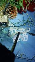 Robotic arms with tiny scissors and claw holding and cutting the paper snowflake. Da Vinci surgical system capabilities to sophisticated work. Close up. Vertical video