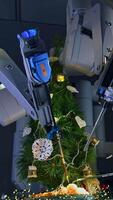 Fantastic work of innovative surgical equipment to decorate New Year tree. Da Vinci robotic arms moving and decorating Christmas tree on the operating table. View from below. Vertical video