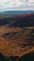 Sunlit scenery of majestic rocks of canyons in Utah, USA. Fascinating panorama of American National park from aerial view. Vertical video