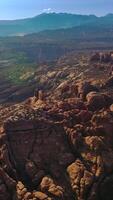 Rising over the stunning scenery of rock formations in Utah, USA. Sunny panorama of beautiful canyons under blue skies. Top view. Vertical video