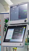 Working screens in the modern surgery room. Close up with gradual distancing. Equipment necessary for present-day operation. Vertical video