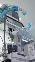 Oxygen mask for general anesthesia with blue tubes. Going round the modern equipment from low angle view. Vertical video