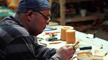 Artisan woodworking in a workshop, Man crafting decorative door, Man working with tools, Showing hard work and skills. High quality 4k footage video