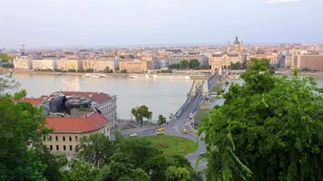 Timelapse of Budapest showing city traffic and walking tourists near Chain Bridge over Danube River. Architecture of capital of Hungary with historical buildings and famous landmarks video