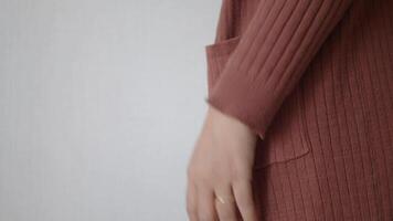 A CloseUp Shot of a Hand Gripping Soft and Comfortable Fabric in Exquisite Warm Tones and Colors video