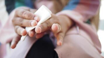woman disinfecting his hands with a wet wipe. video