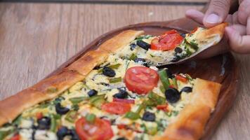 Turkish pide traditional food with beef and vegetables. video
