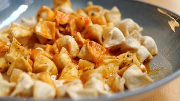 A delicious plate filled with fried dumplings served alongside a tantalizing spicy sauce video