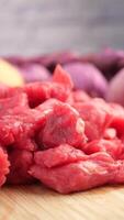 Delicious Fresh Raw Beef Chunks Combined with Colorful Vegetables Displayed on Wooden Surface video