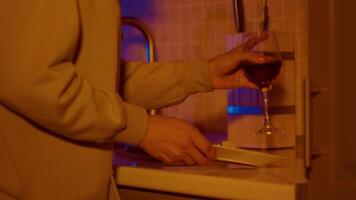 Hands of woman picking up plate with cheese and glass of wine. video