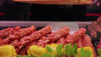 Close up turkish kebab lamb meat on skewers in supermarket. video