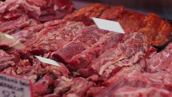 Display of assorted chopped raw lamb meat in butchers shop for sale. video