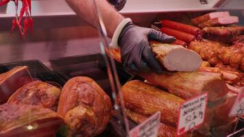 Man filling the fridge with fresh meat cuts. video