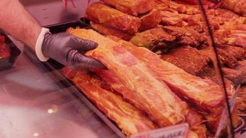 Close up shot of dried and smoked meat production on display in a shop. video