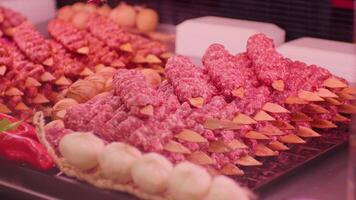 Turkish kebab on skewers with spices on showcase in butchers shop. video