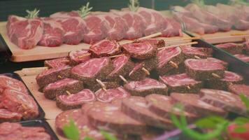 Butchers shop display window meat arrangment either for grill or barbeque. video
