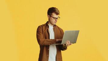 Web developer working on laptop with changing facial expressions video