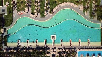 Top down aerial view of pool on grounds of a luxury hotel in tropics. Palm trees video
