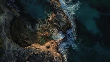 Top view of the powerful turquoise waves crashing against the rocks of Macao into thousands of sparkling splashes in the Dominican Republic at sunset of the warm sun. video